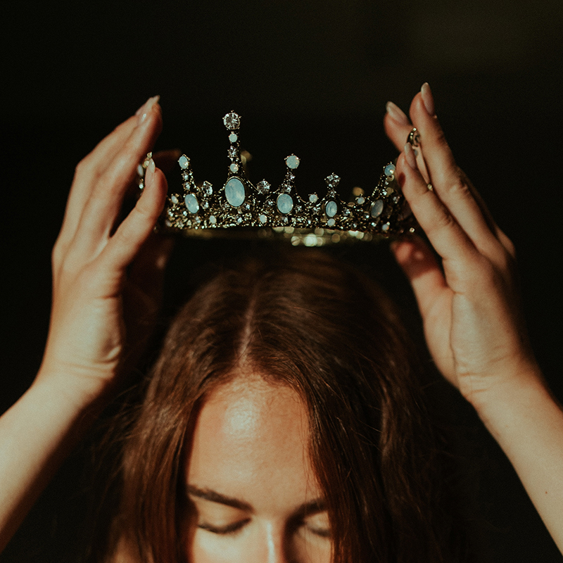 A photograph from Jared Subia showing a woman crowning herself with a tiara.